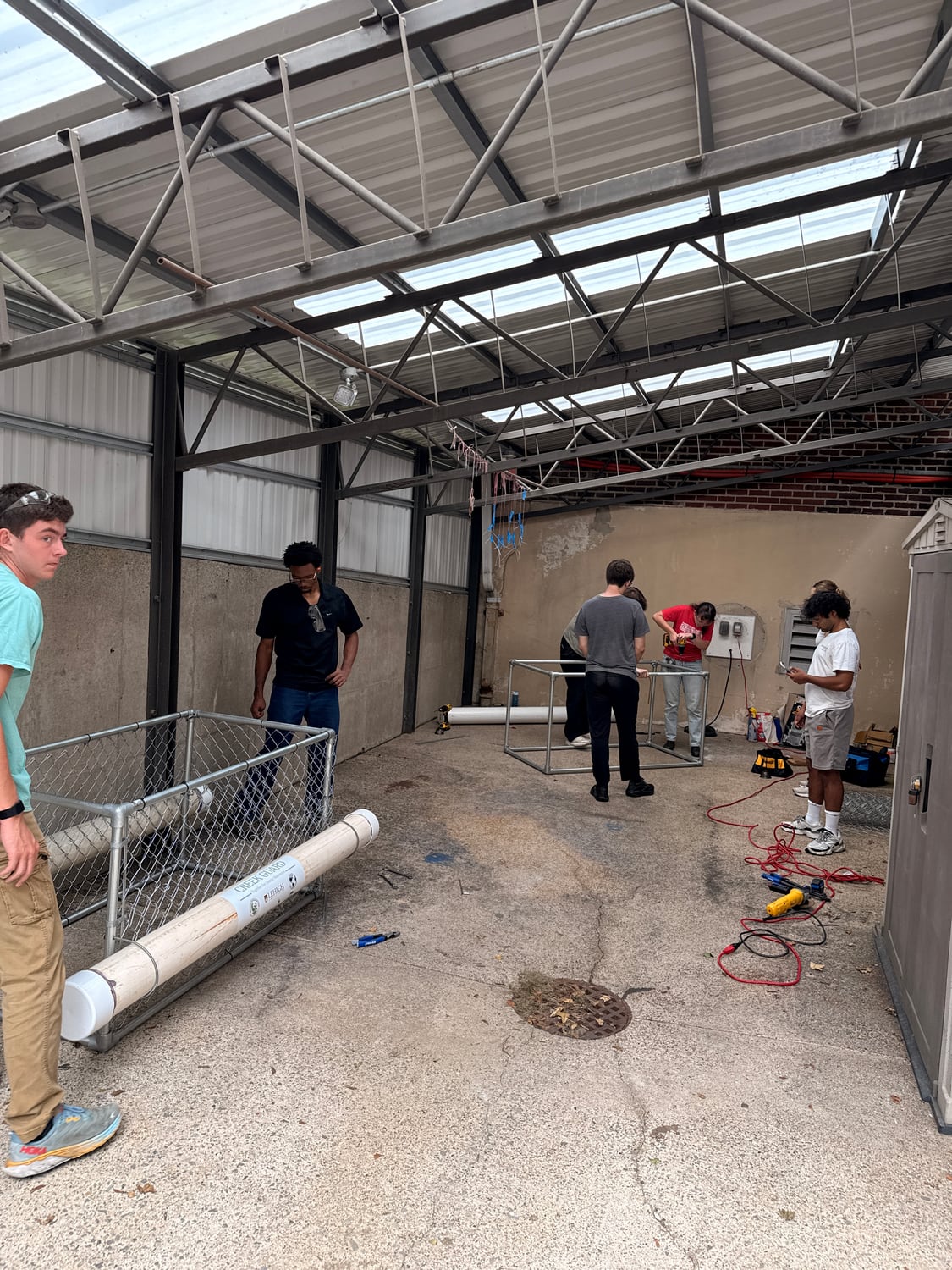 Club members assembling Creek Guard units in the workshop bay.