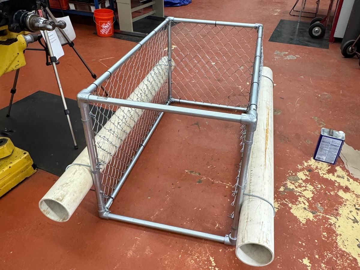 The completed Creek Guard with both flotation pipes fitted and the project label attached.